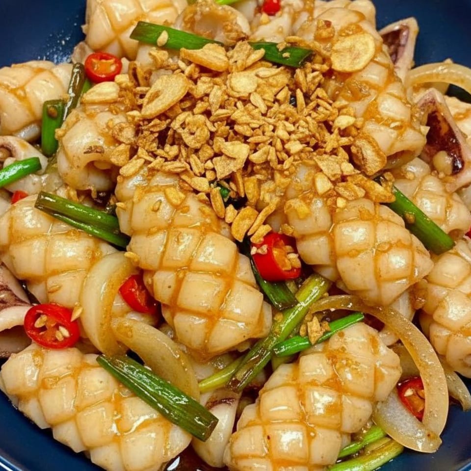 Thai Bangkok Bistro's stir-fried squid with onions, green onions, red chilies, and crispy garlic.